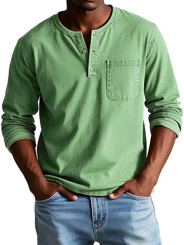 Full shot of a man wearing a stylish long sleeve button neck shirt, showcasing its casual relaxed fit.