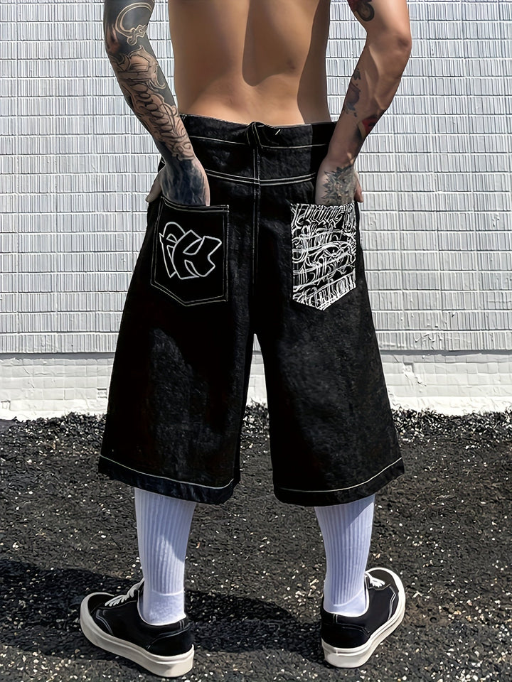 Close-up of men's loose fit Bermuda shorts, showcasing detailed floral embroidery on denim.