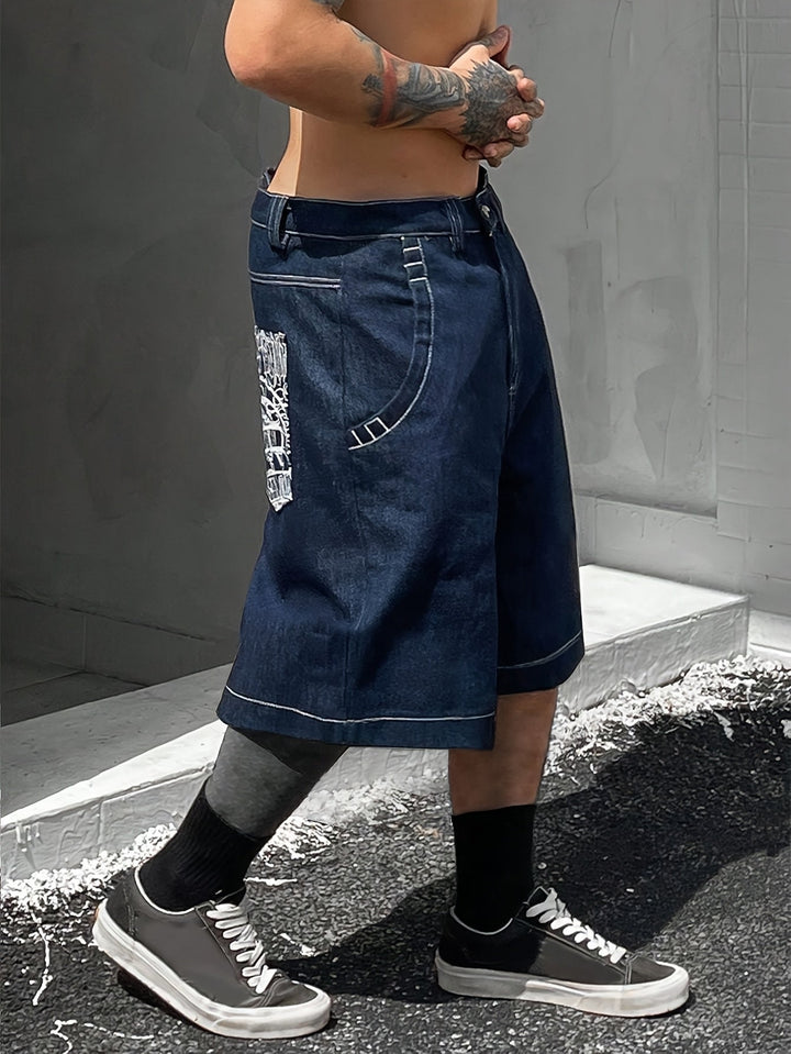 Front view of men's stylish loose fit Bermuda shorts, denim with unique floral embroidery.