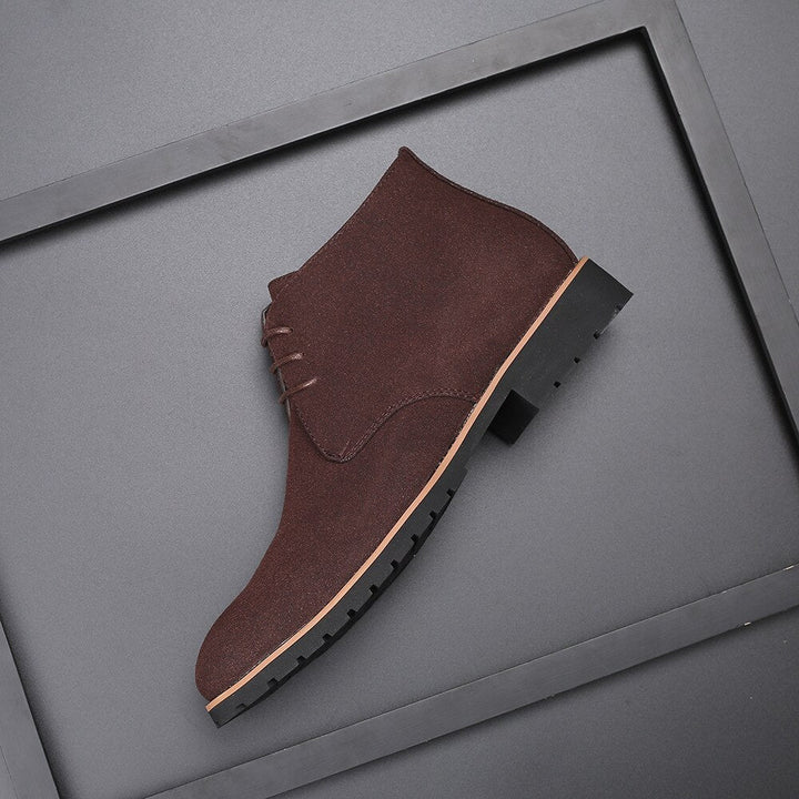 Closeup of men's tan ankle boots, emphasizing quality material and casual footwear design.