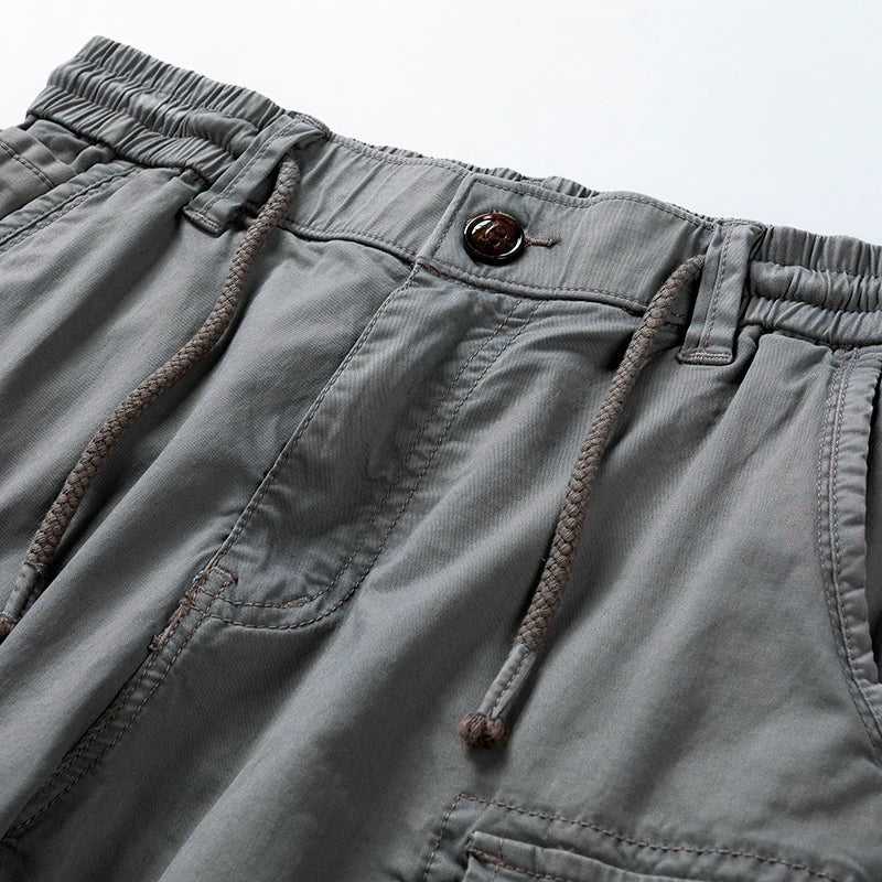 Stylish grey men's casual cargo shorts with drawstring waist. Perfect for summer utility and comfort.