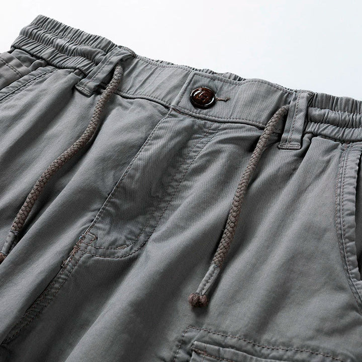 Stylish grey men's casual cargo shorts with drawstring waist. Perfect for summer utility and comfort.