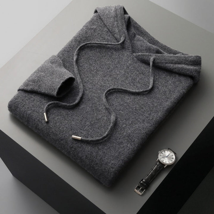 Close-up of a men's hooded sweater, showcasing the soft knit texture and ribbed cuffs for spring comfort.