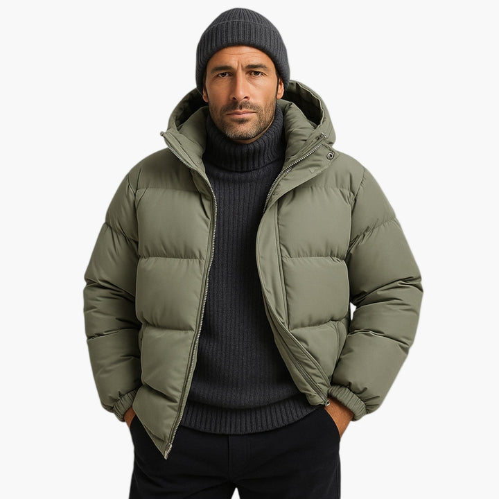 Detail of zipper and hood on men's warm quilted puffer jacket, robust outerwear
