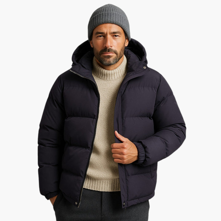 Close-up of quilted pattern on men's black hooded puffer jacket, warm outerwear