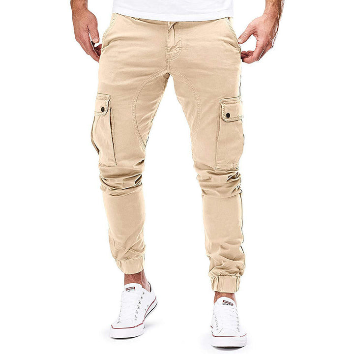 Close-up of men's casual utility trousers, sand color, highlighting durable fabric and pocket detail