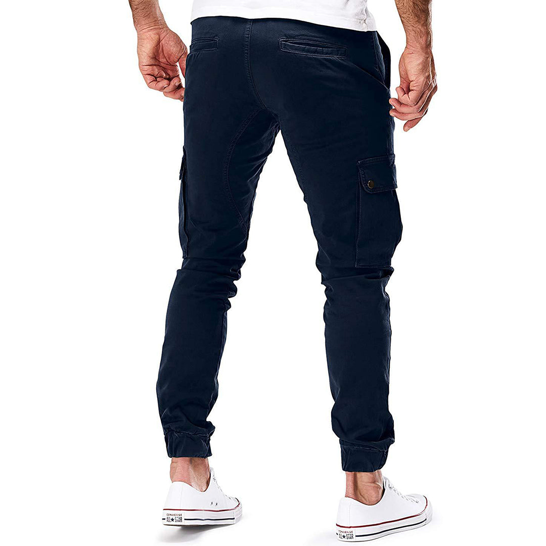 Folded men's casual utility pants, dark green, emphasizing soft material and spacious pockets