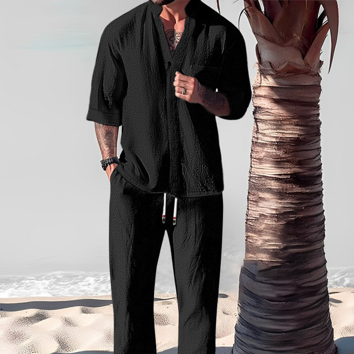 Men's casual two-piece set featuring a relaxed shirt and comfortable trousers. Perfect for summer resort wear.