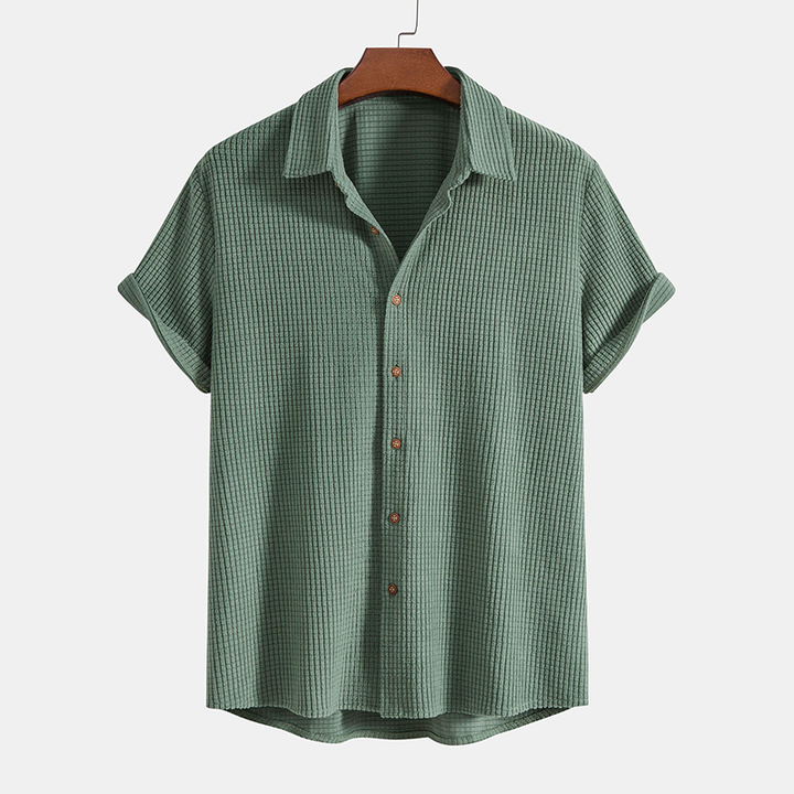 Comfortable men's two-piece lounge set with short-sleeve shirt & shorts for warm weather casual wear.