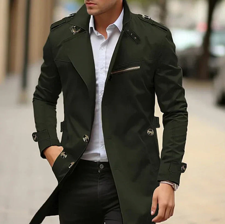 Man modeling a stylish green men's trench coat, perfect spring outerwear for a sophisticated, classic look.