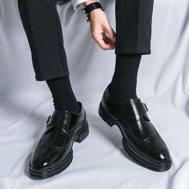 Sophisticated men's brown leather monk strap wingtip dress shoes, ideal for formal and business occasions.