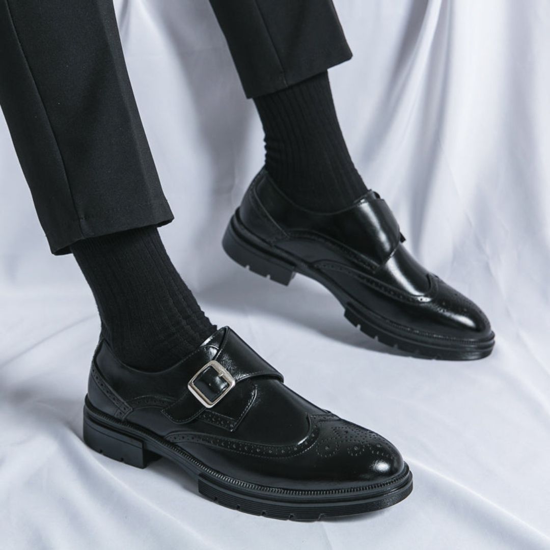 Side view of polished black men's double monk strap wingtip dress shoes, perfect for professional fashion.
