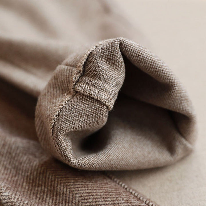 Detail of pleats on men's herringbone dress trousers, ideal for smart casual wear