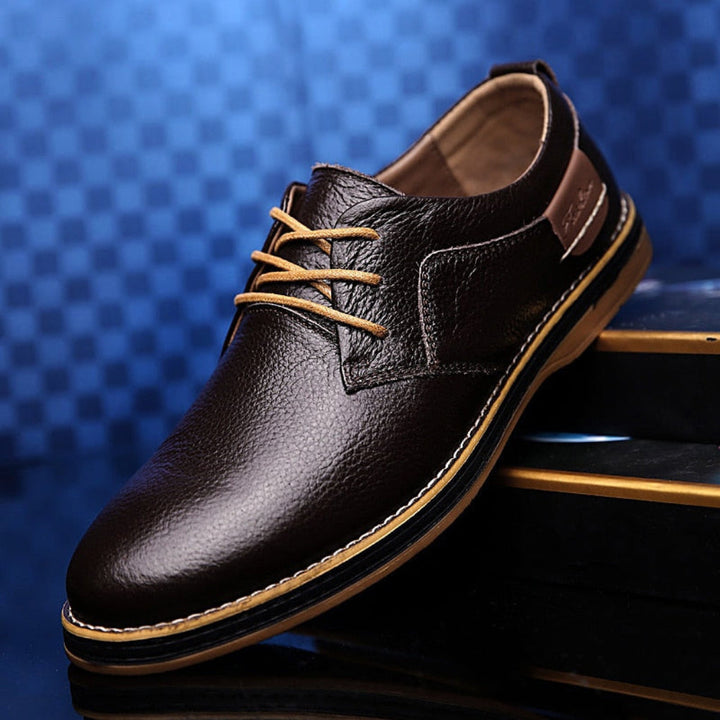 Men's classic brown leather Oxford dress shoes, perfect for formal business attire and comfortable all-day wear.