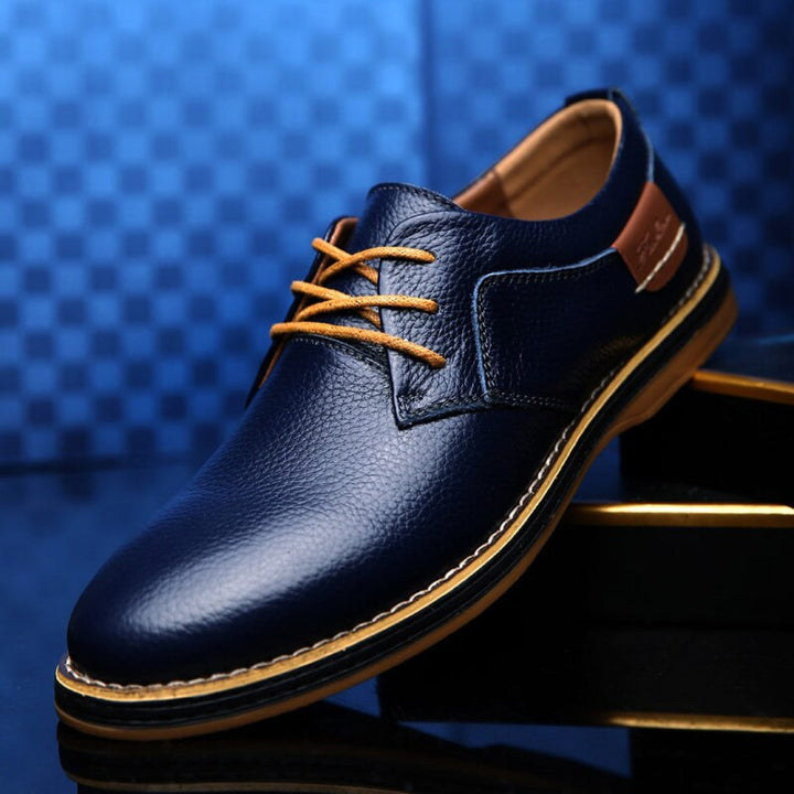Elegant black Oxford dress shoes for men, featuring timeless style, waterproof design, and comfort for work or casual.