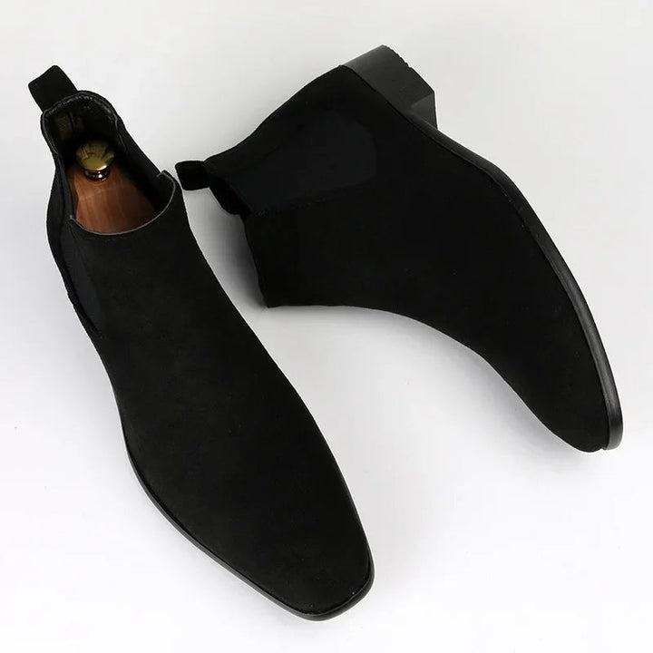Side view of men's grey suede Chelsea boot, featuring an ankle-high cut and slip-on design
