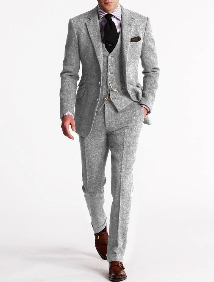 Close-up of a men's classic tweed suit fabric, highlighting the texture and quality for formal wear.
