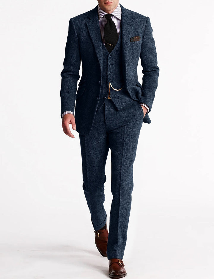 Full-length view of a gentleman modeling a timeless men's tweed three-piece suit, wedding appropriate.