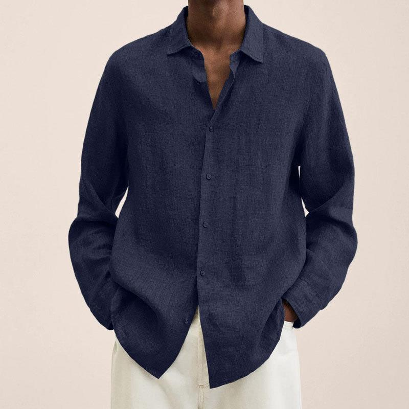 Man adjusting cuff of a classic long sleeve button down men's shirt, emphasizing breathability.