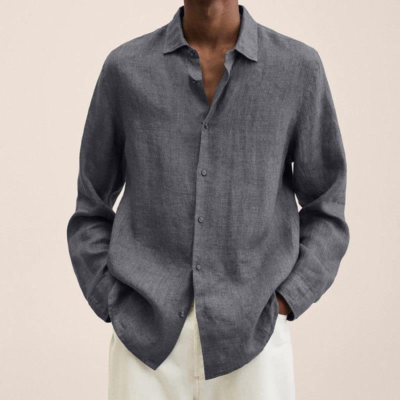 Flat lay of a men's casual long sleeve button down shirt with jeans and accessories.