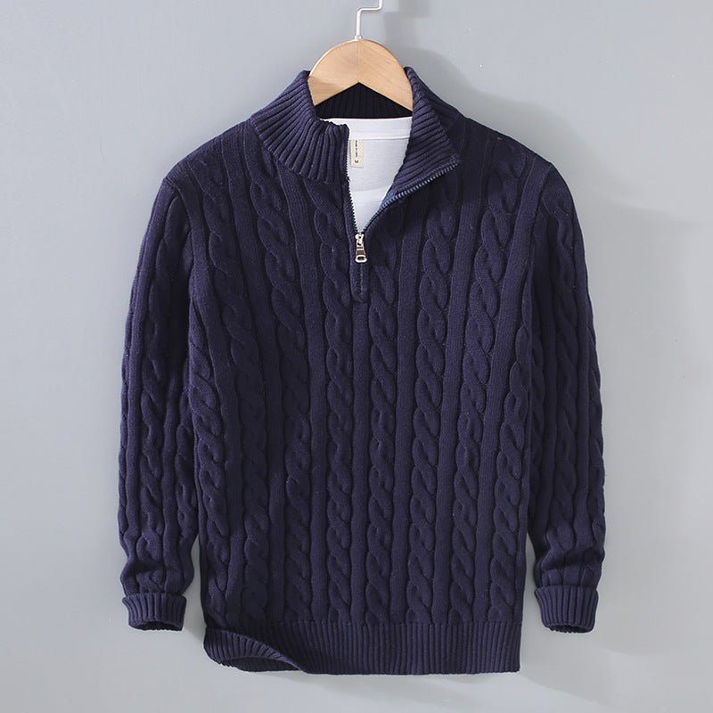 Close-up of a men's cable knit quarter-zip sweater showing intricate patterns and premium texture.
