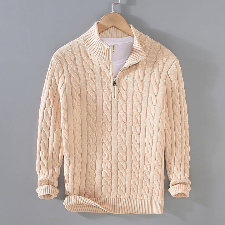 Detail shot of the collar and zipper on a men's cable knit sweater, highlighting its casual elegance.