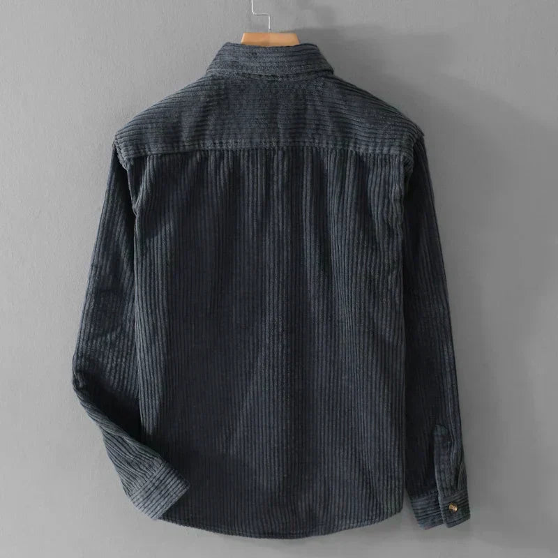 Close-up of a men's stylish corduroy shirt, showing ribbed texture fabric and classic long-sleeve details.