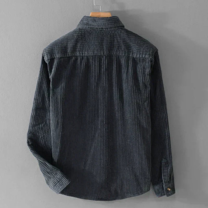 Close-up of a men's stylish corduroy shirt, showing ribbed texture fabric and classic long-sleeve details.