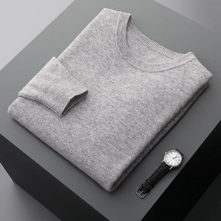 Close-up of the textured knit on a men's classic long sleeve crew neck pullover sweater.