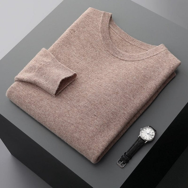 Detail of the ribbed cuffs and hem on a men's long sleeve classic pullover sweater.