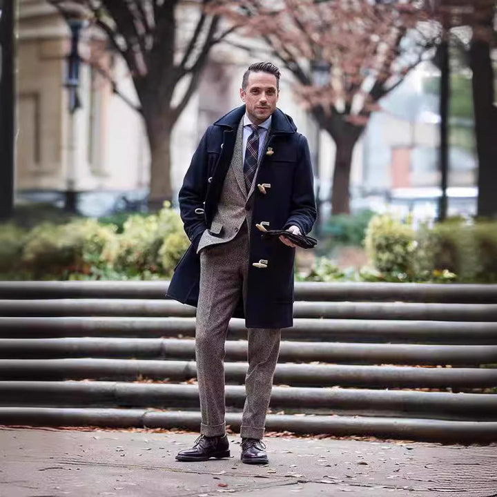Classic men's duffle coat for winter, featuring distinctive toggle closures and hood, ideal for cold weather.