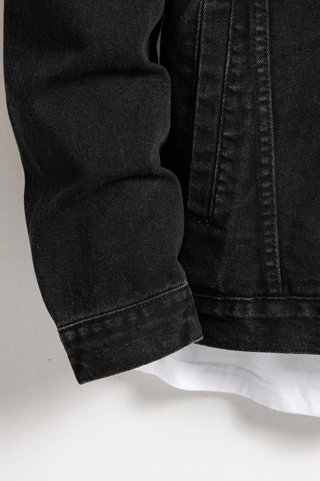 Front view of men's classic fit black denim jacket. Button-up closure, a timeless and structured casual outerwear.