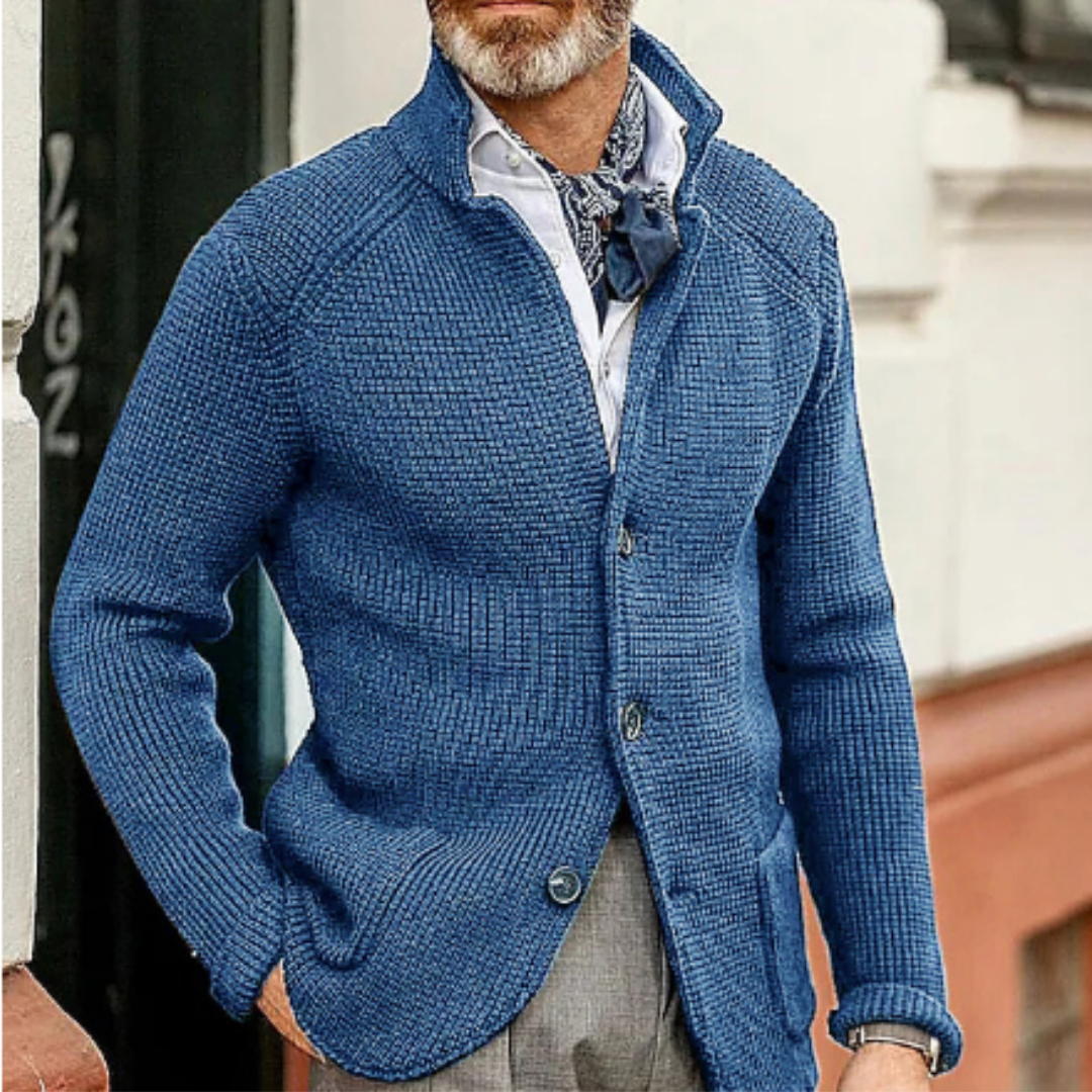 Men's navy button-up cardigan styled over a white shirt, showcasing classic layering fashion.