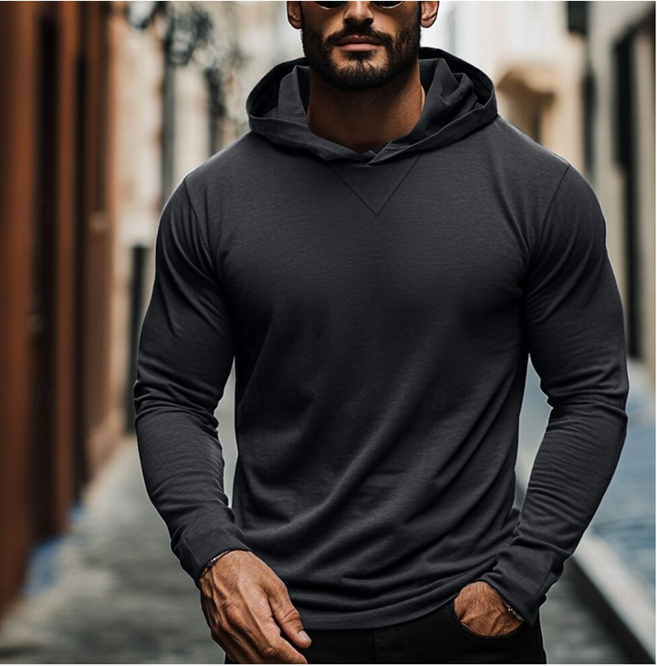 Man wearing a comfortable men's pullover hoodie, perfect for versatile casual wear and modern fashion.