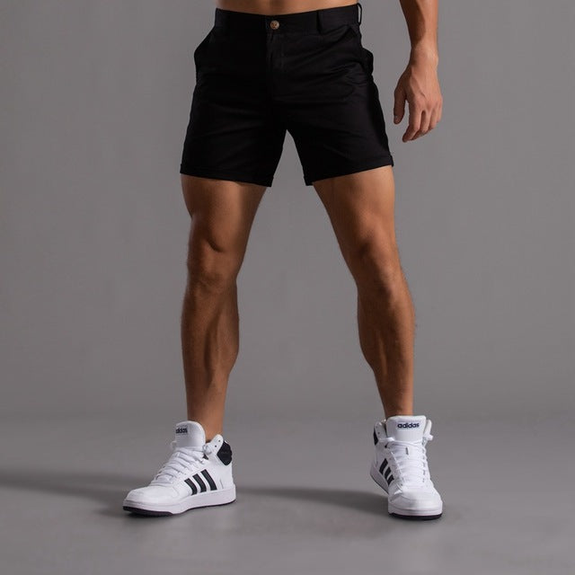 Man wearing classic men's chino shorts, showcasing comfort and casual style for summer activities.
