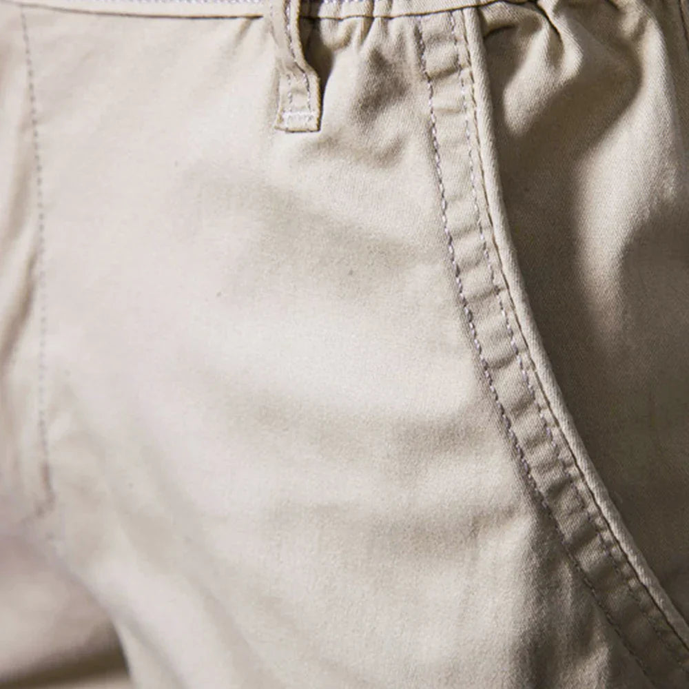 Man wearing versatile men's khaki chino shorts, perfect for a casual summer day out.