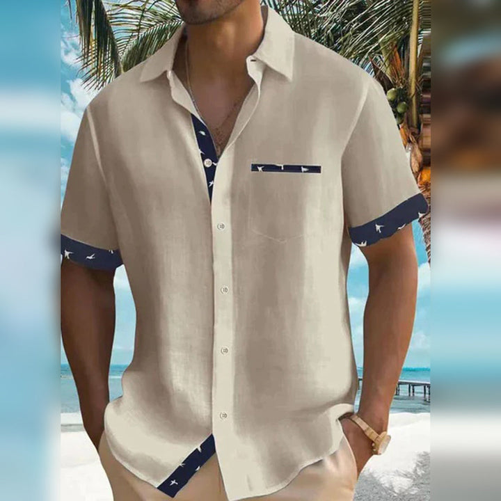 Detail view of a men's slim fit button-down shirt, highlighting the fabric texture and classic button design.