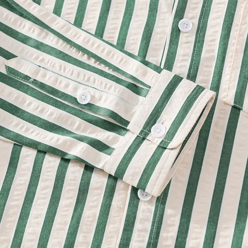 Close-up of a men's classic striped button-down shirt, showcasing fabric texture and button details.