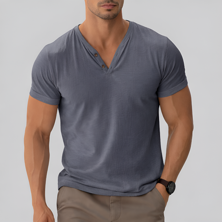 Stack of men's classic V-neck t-shirts in various colors including blue, grey, and white, cotton blend.