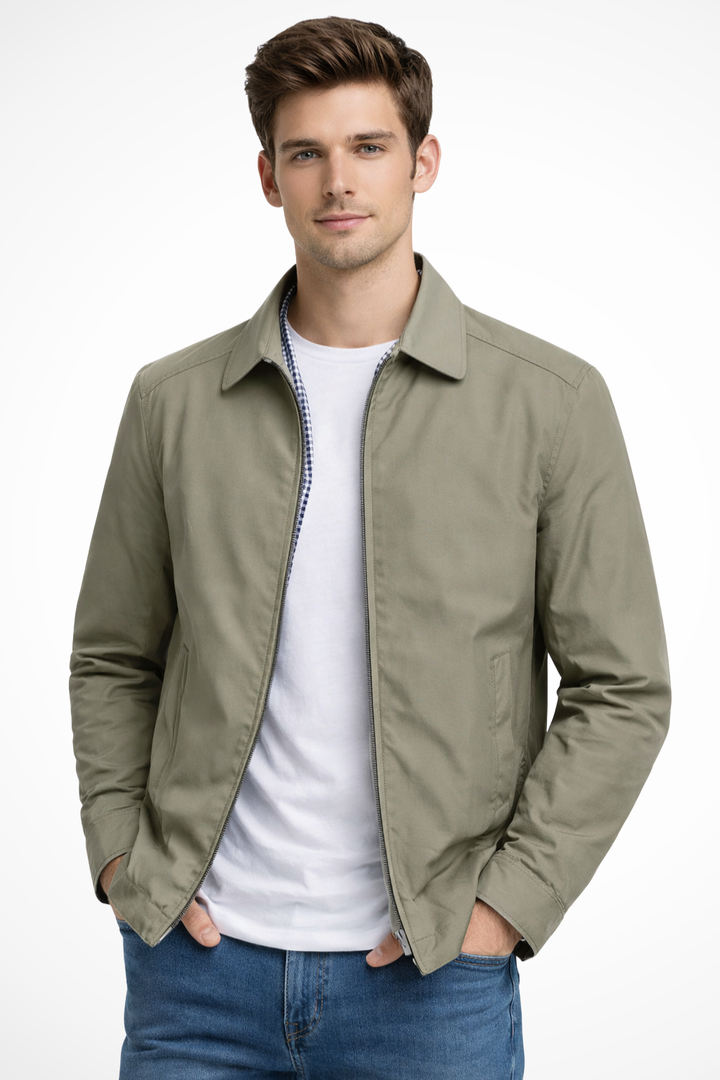Close-up of men's collared Harrington jacket, highlighting its check lining, ribbed cuffs, & sturdy zip closure detail.