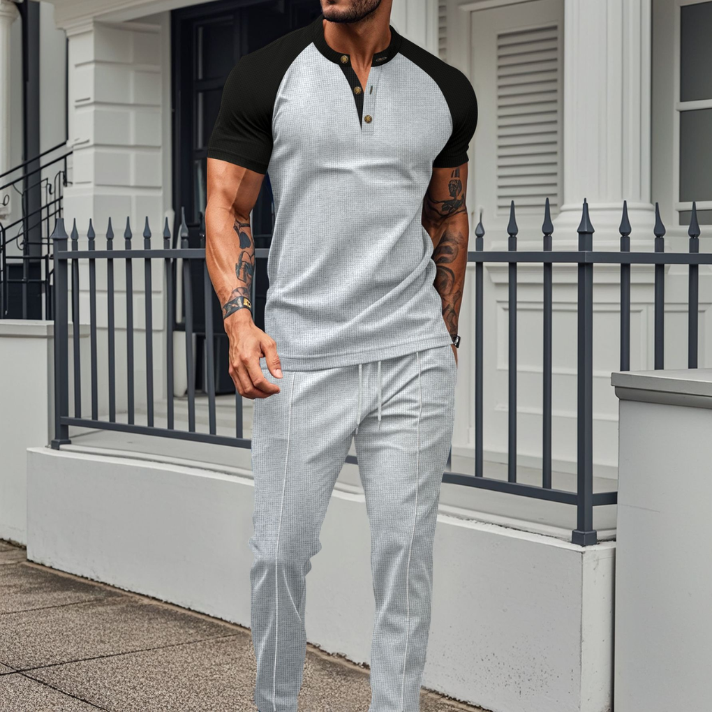 Close-up of men's contrast Henley shirt & jogger pants tracksuit set, ideal for comfort & sportswear.