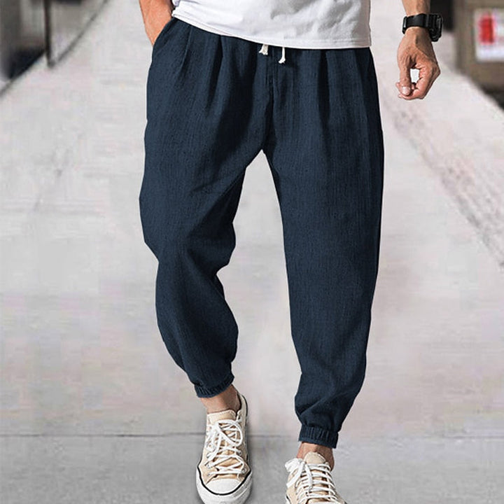 Men's soft cotton blend jogging pants with elastic waist, designed for casual comfort & style.
