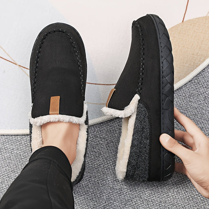 Comfortable men's indoor slippers with a plush sheepskin lining and non-slip grip.