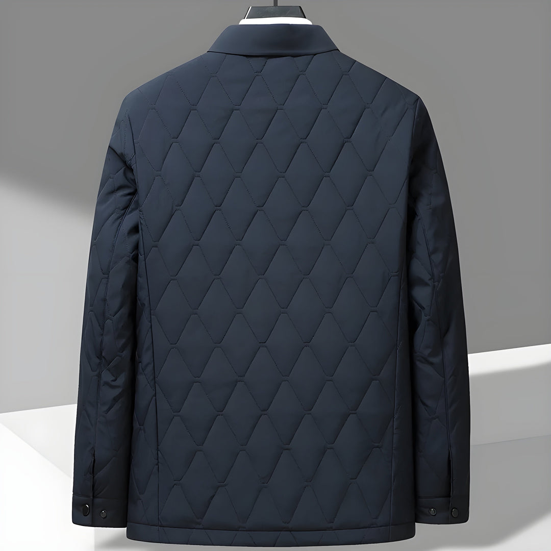 Textured men's quilted jacket with a distinct diamond stitch pattern & classic shirt collar. Durable outerwear.