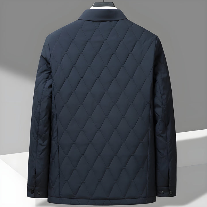 Textured men's quilted jacket with a distinct diamond stitch pattern & classic shirt collar. Durable outerwear.