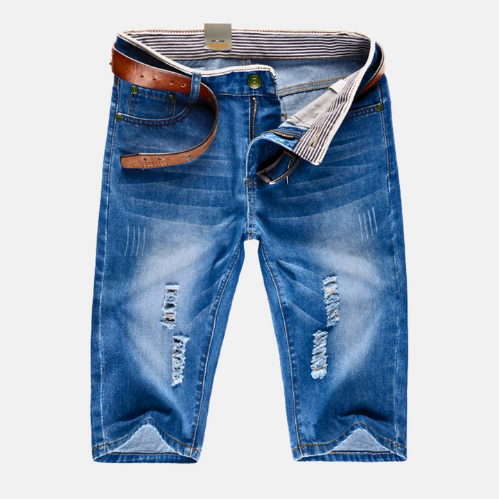Men's distressed ripped streetwear shorts, rugged & stylish for casual urban summer fashion.