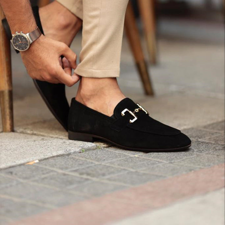Black patent leather men's horsebit loafers with a polished finish, offering a classic and sophisticated footwear option.
