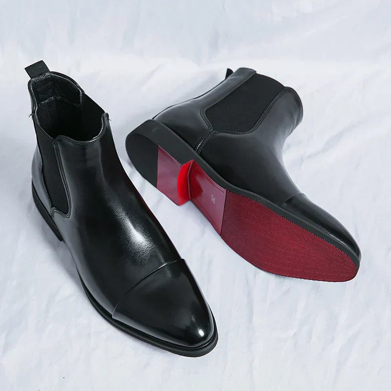 Men's elegant black leather slip-on boots for formal occasions or sophisticated casual wear.