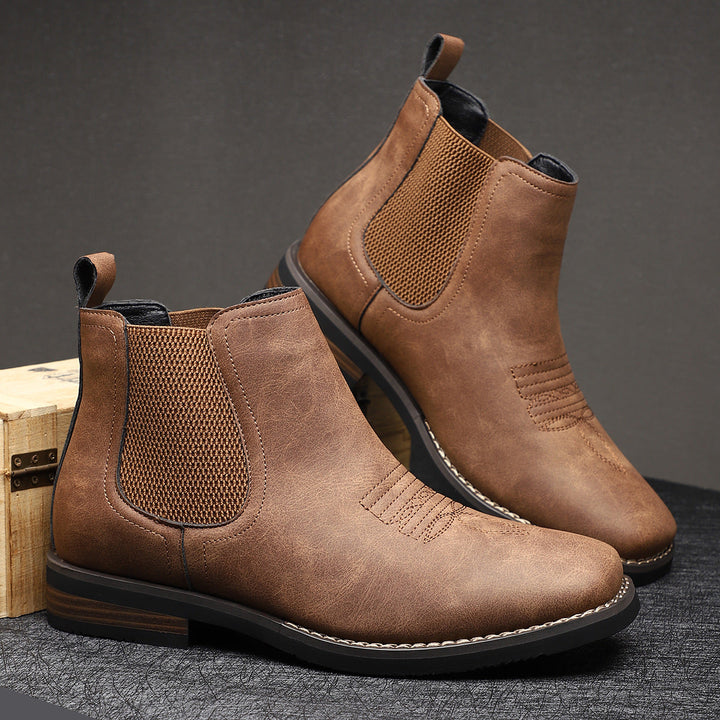 Classic black men's Chelsea ankle boots, perfect for dress or casual wear, featuring a sleek design.