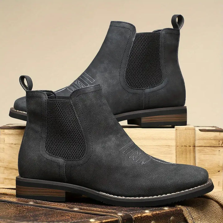 Full shot of elegant men's brown Chelsea boots, highlighting the sophisticated square toe and ankle height.